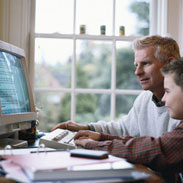 Father And Son Using Computer