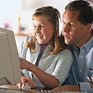 Father And Daugther Using Computer